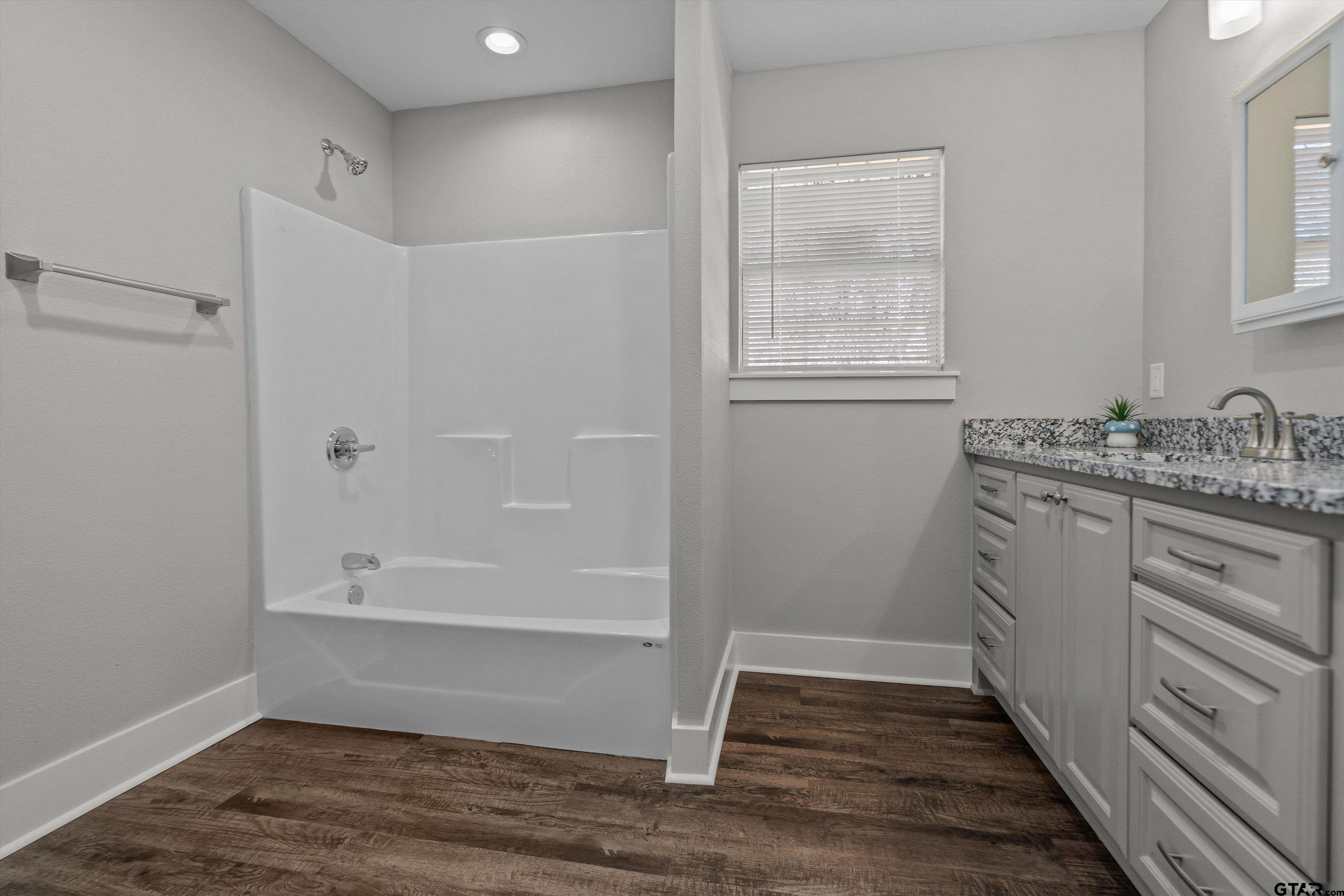 5881 Jefferson Avenue Tyler, TX 75708 - Photo 15 of 20 a bathroom with a sink and a window