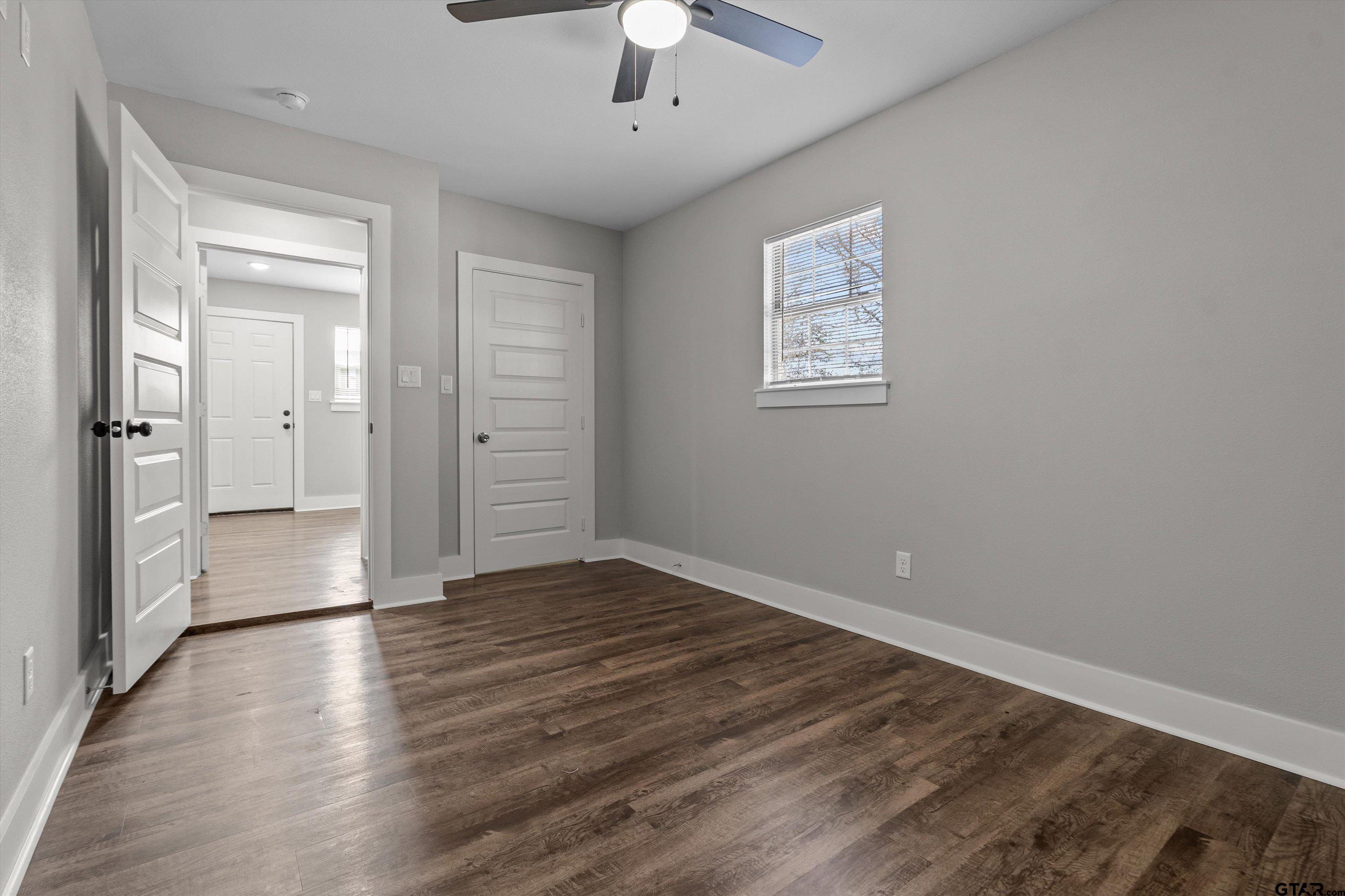 5881 Jefferson Avenue Tyler, TX 75708 - Photo 16 of 20 wooden floor in an empty room with a window
