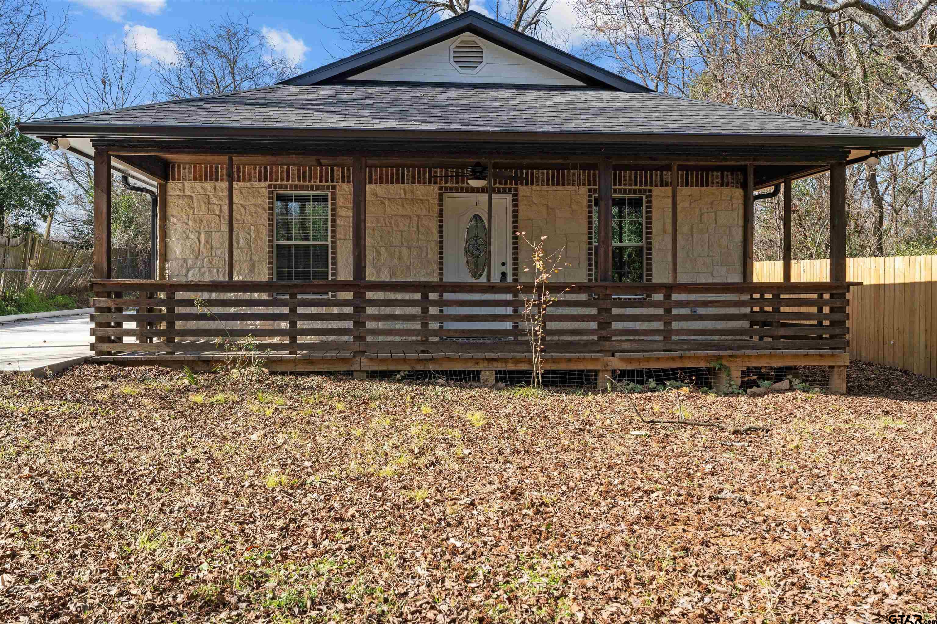 5881 Jefferson Avenue Tyler, TX 75708 - Photo 2 of 20 a front view of a house with a garden
