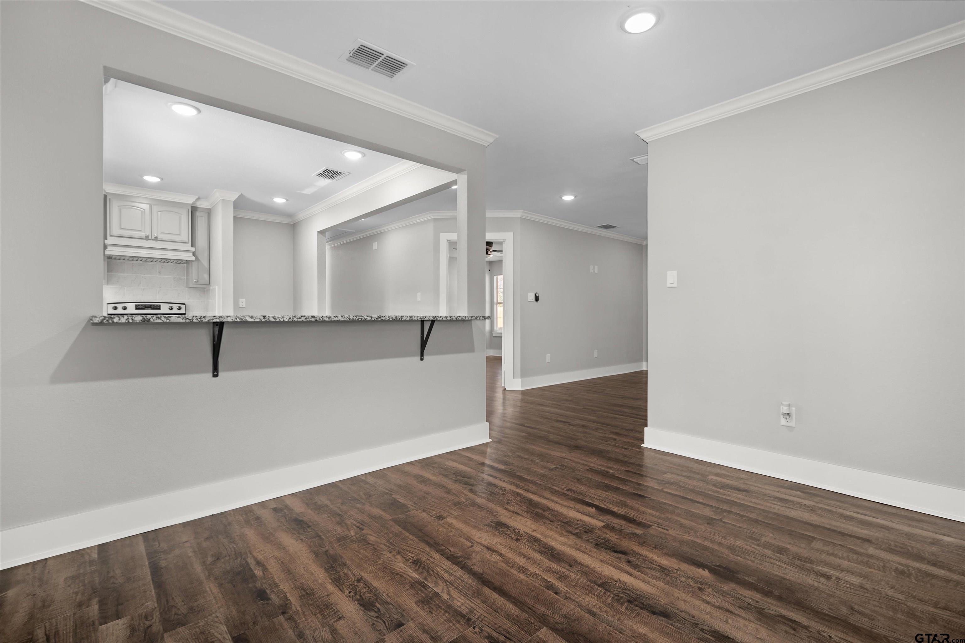 5881 Jefferson Avenue Tyler, TX 75708 - Photo 8 of 20 an empty room with wooden floor and windows