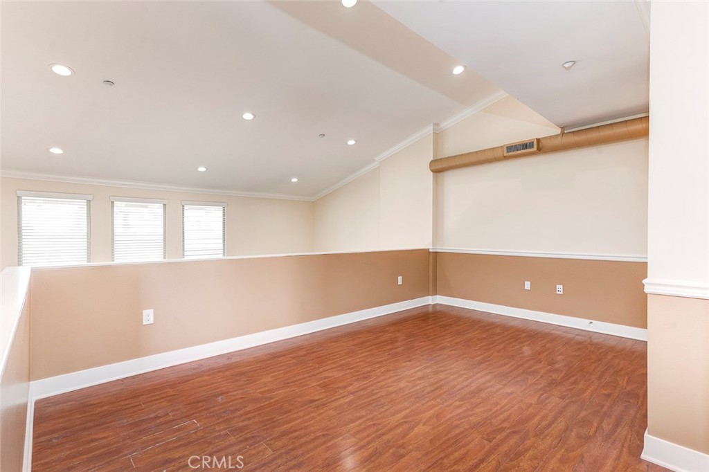 596 South Brea Boulevard Brea, CA 92821 - Photo 20 of 33 an empty room with wooden floor and windows