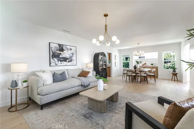 a living room with furniture and view of kitchen