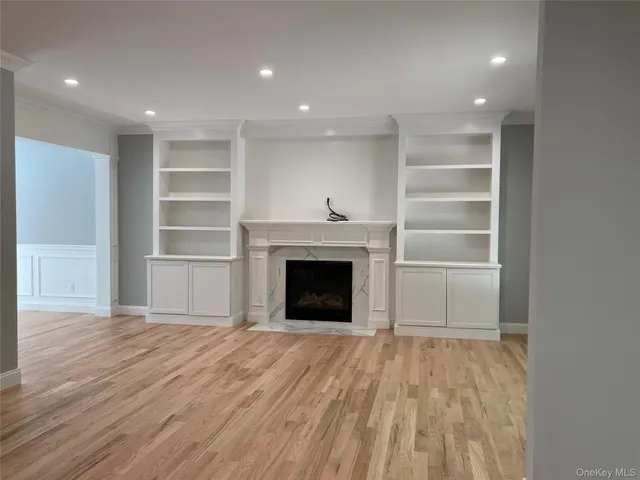 a view of a livingroom with a fireplace cabinet and window