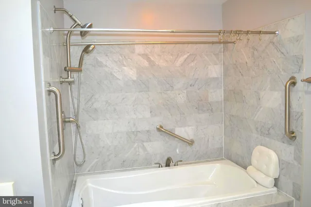a bathroom with a white bath tub and a shower