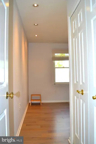 a view of a hallway view with wooden floor and staircase