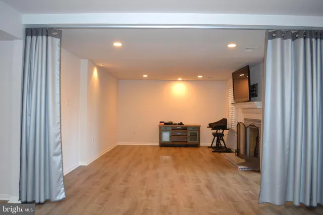a view of a livingroom with a furniture wooden floor and a window