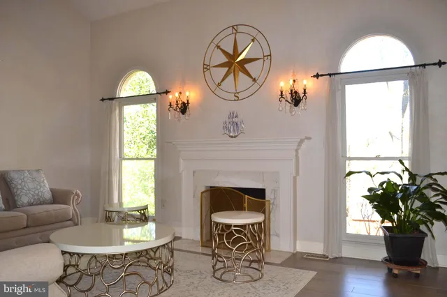 a living room with furniture a window and a fireplace