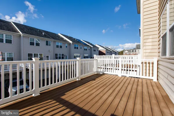 a view of a wooden deck with large windows