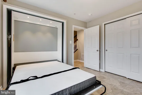 a bedroom with a bed and a mirror