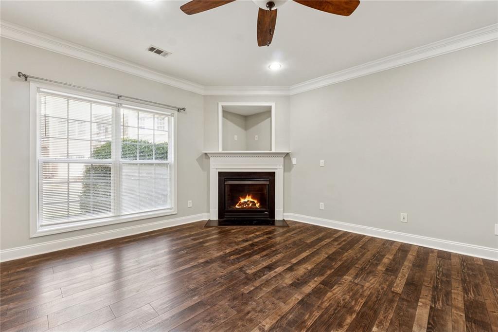 3184 Buck Way Alpharetta, GA 30004 - Photo 12 of 48 a view of an empty room with wooden floor fireplace and a window
