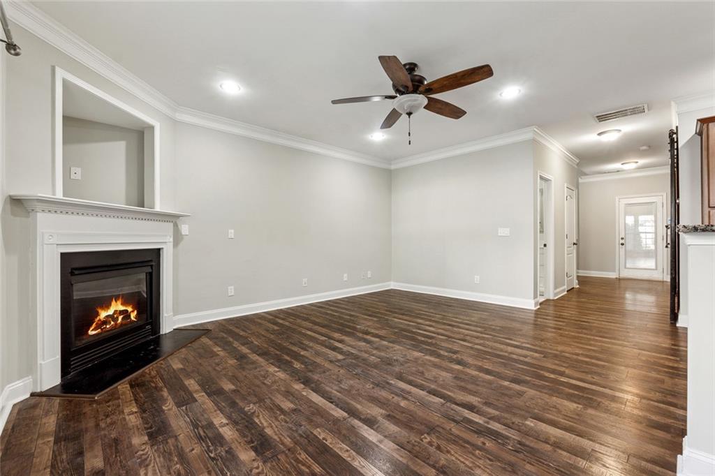 3184 Buck Way Alpharetta, GA 30004 - Photo 14 of 48 a view of an empty room with wooden floor fireplace and a window