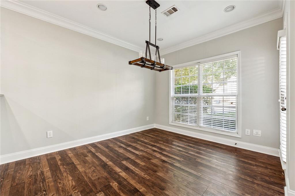 3184 Buck Way Alpharetta, GA 30004 - Photo 15 of 48 a view of a room with wooden floor a ceiling fan and a window