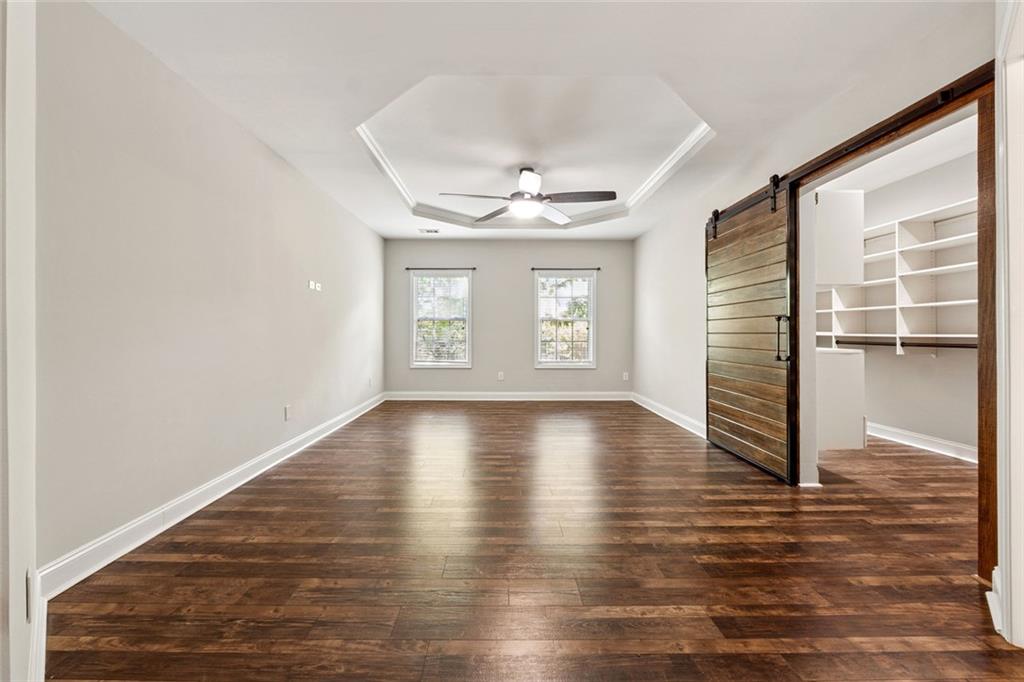 3184 Buck Way Alpharetta, GA 30004 - Photo 19 of 48 an empty room with wooden floor and windows