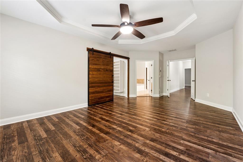 3184 Buck Way Alpharetta, GA 30004 - Photo 20 of 48 an empty room with wooden floor chandelier fan and windows