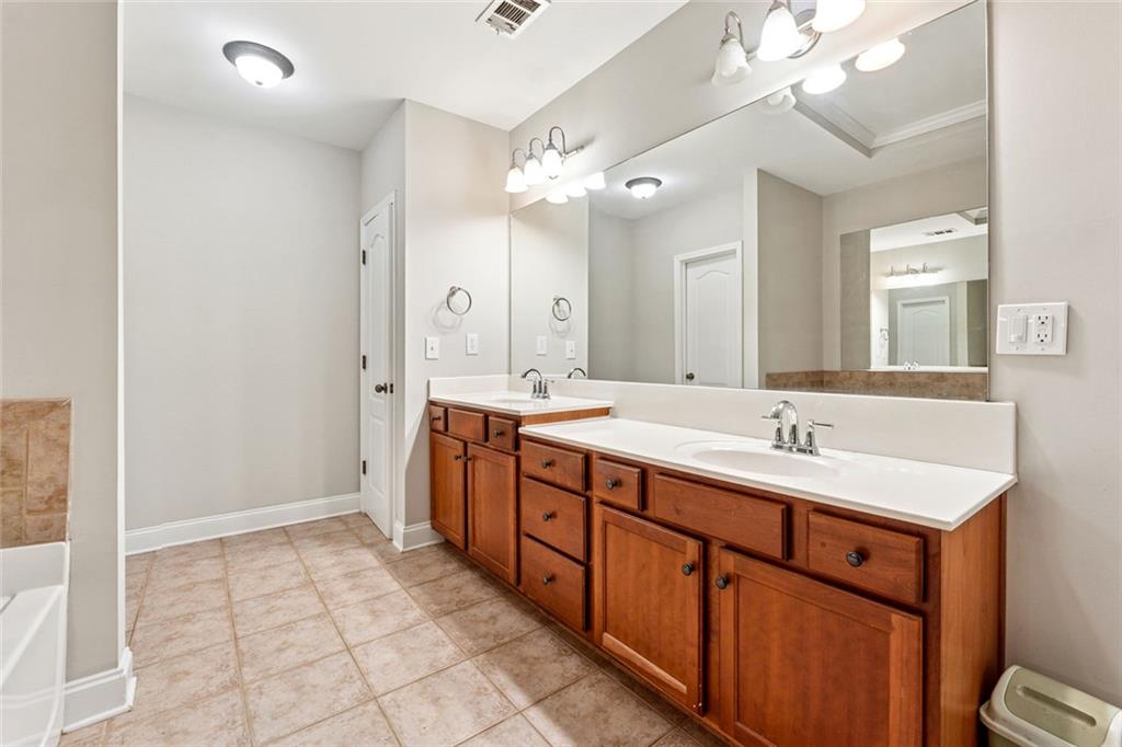 3184 Buck Way Alpharetta, GA 30004 - Photo 25 of 48 a spacious bathroom with a double vanity sink a mirror and a shower