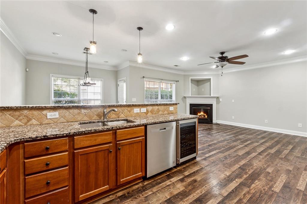 3184 Buck Way Alpharetta, GA 30004 - Photo 9 of 48 a kitchen with stainless steel appliances granite countertop a sink a stove and a wooden floors
