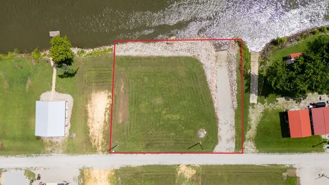 an aerial view of a house with a swimming pool and outdoor seating