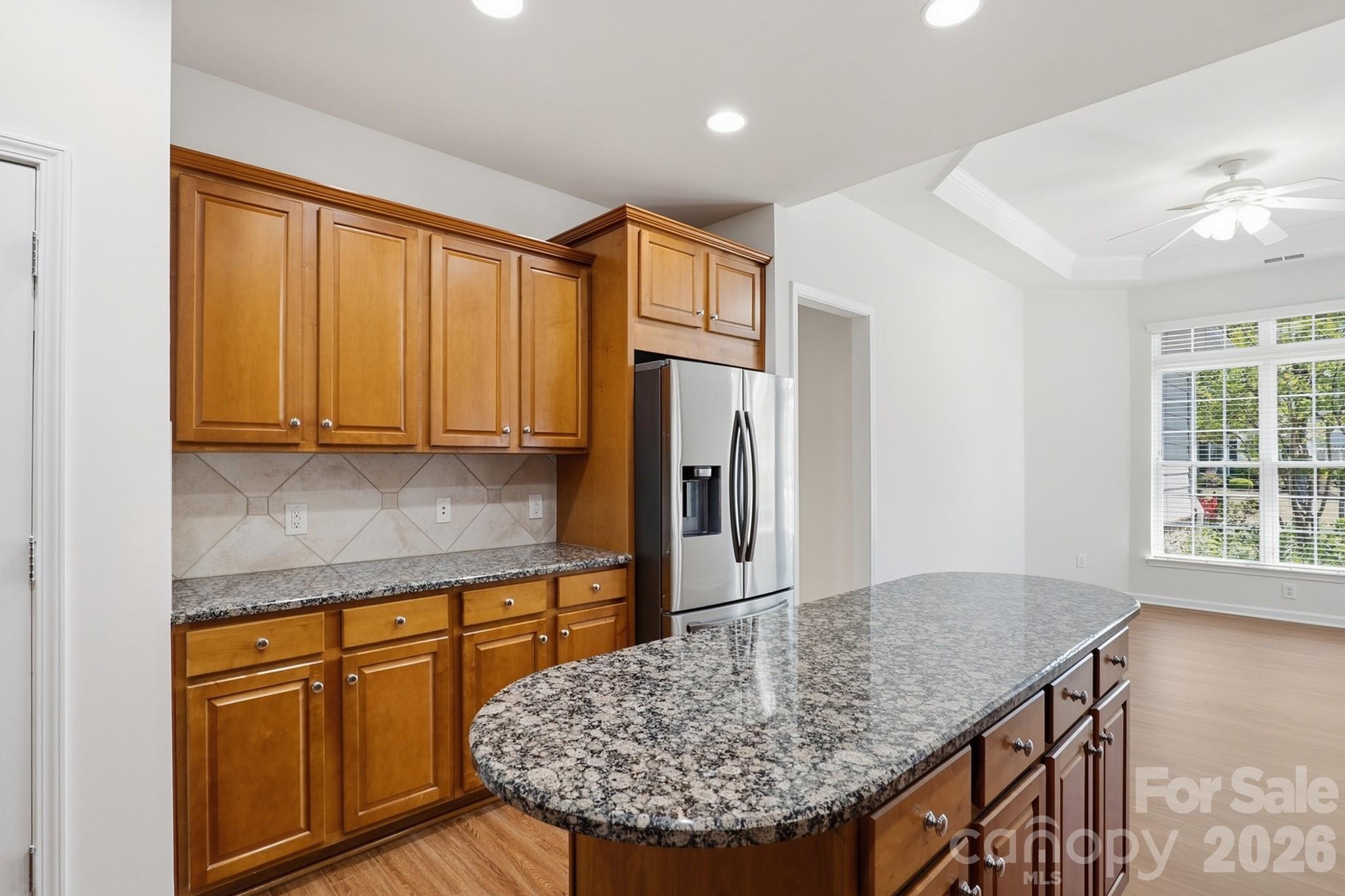 2818 Mandarin Street Fort Mill, SC 29707 - Photo 12 of 48 a kitchen with stainless steel appliances granite countertop a refrigerator a stove and a sink with wooden floor