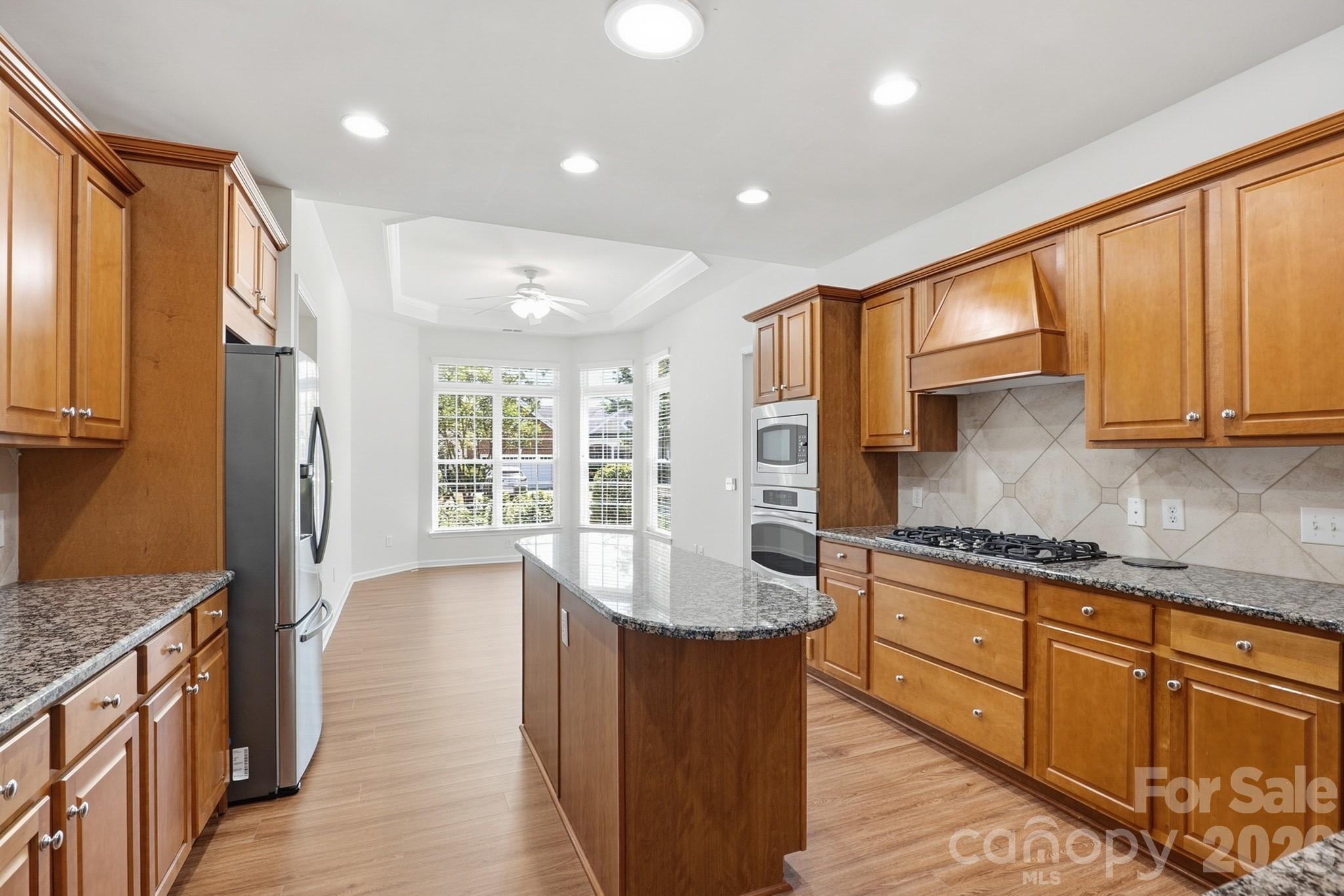 2818 Mandarin Street Fort Mill, SC 29707 - Photo 13 of 48 a large kitchen with kitchen island granite countertop a large window