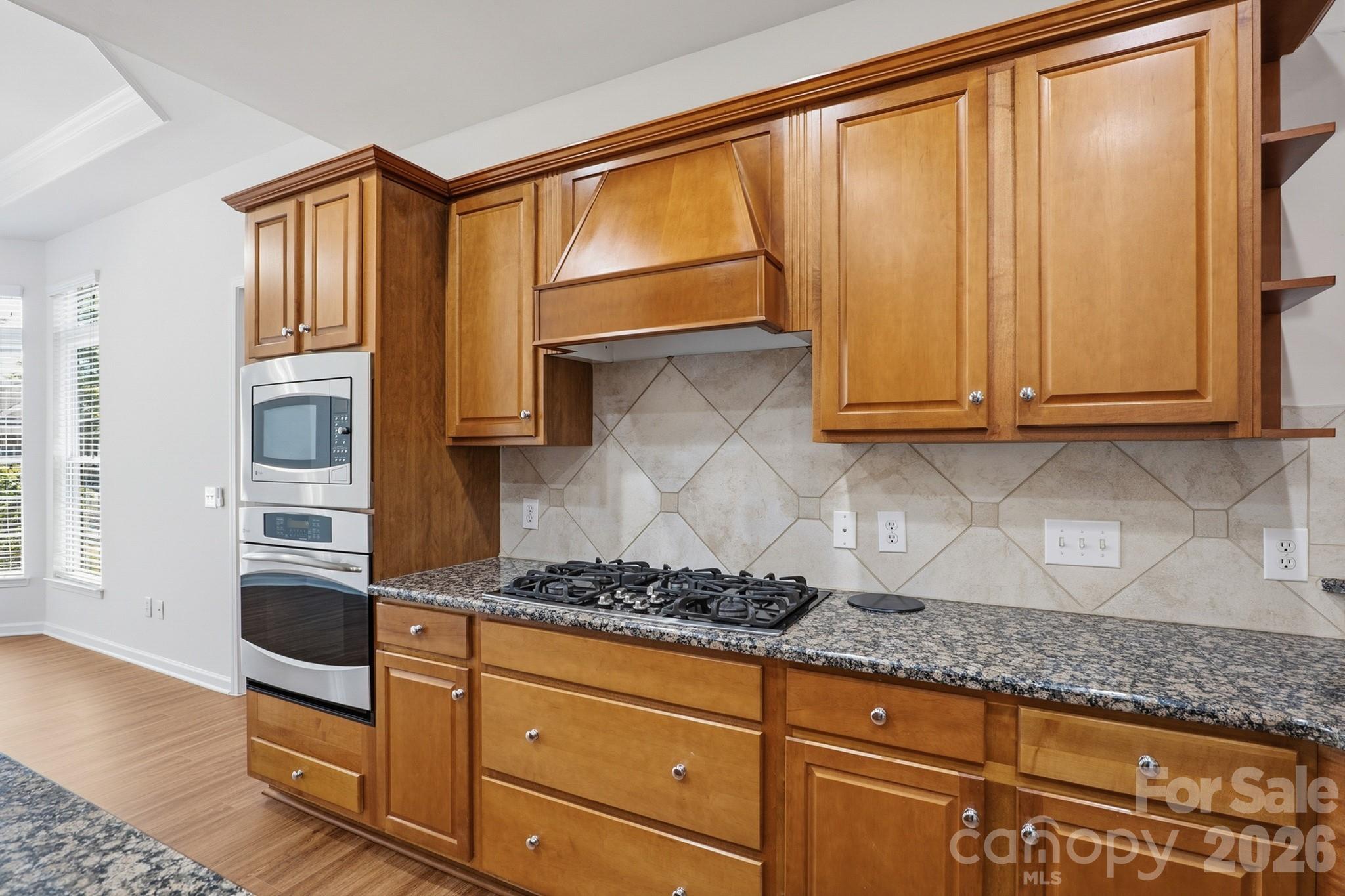 2818 Mandarin Street Fort Mill, SC 29707 - Photo 14 of 48 a kitchen with granite countertop cabinets stainless steel appliances and a counter space