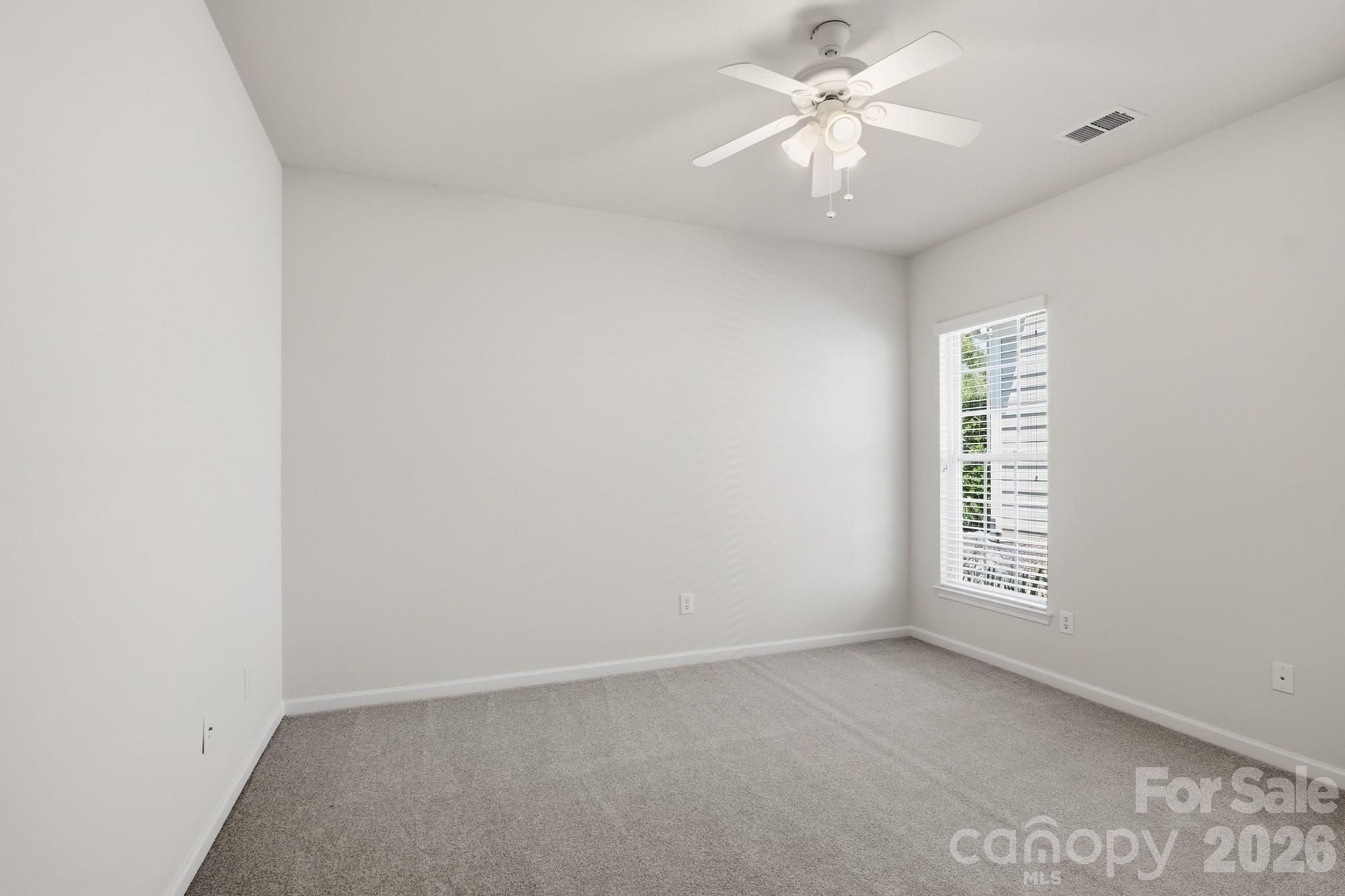 2818 Mandarin Street Fort Mill, SC 29707 - Photo 25 of 48 an empty room with windows and ceiling fan