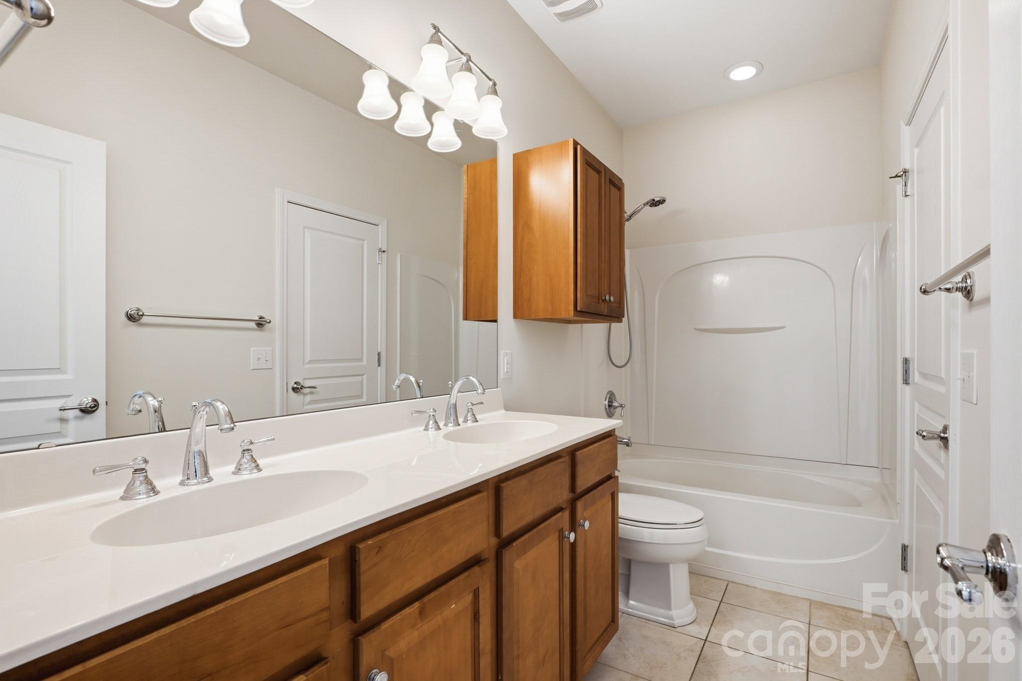2818 Mandarin Street Fort Mill, SC 29707 - Photo 27 of 48 a bathroom with a sink a toilet a mirror and shower