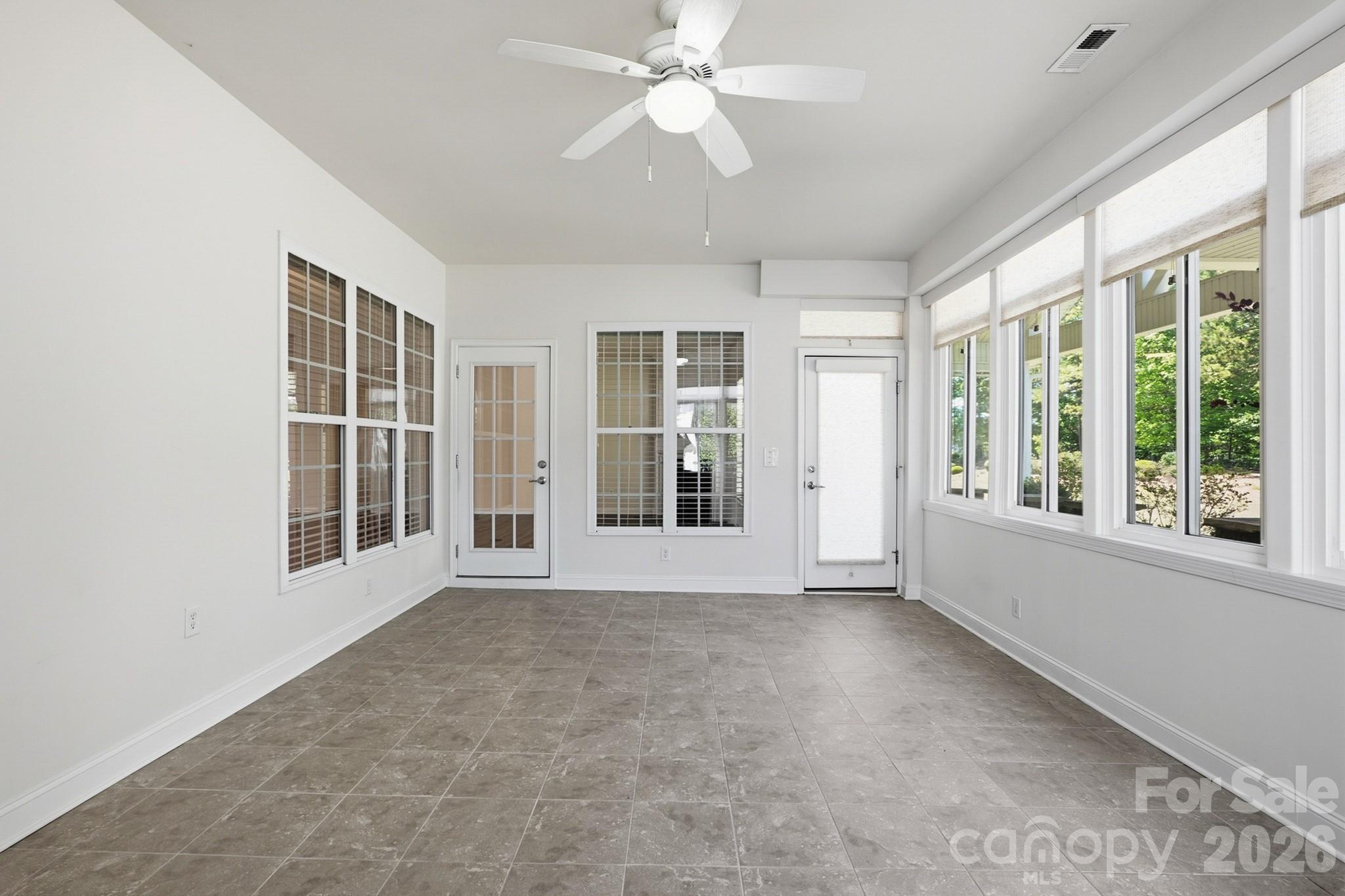 2818 Mandarin Street Fort Mill, SC 29707 - Photo 34 of 48 an empty room with chandelier fan and windows