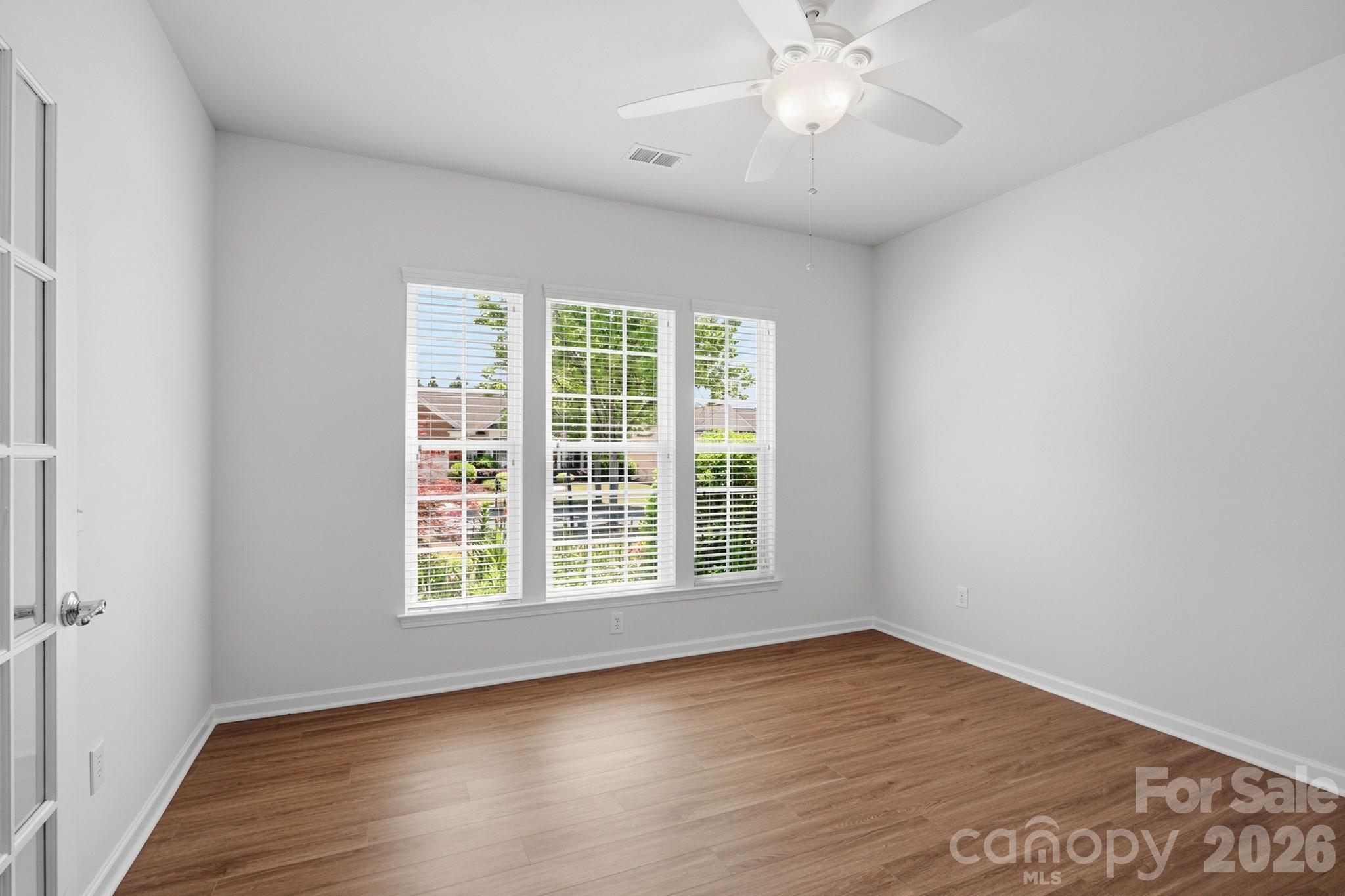 2818 Mandarin Street Fort Mill, SC 29707 - Photo 5 of 48 a view of an empty room with wooden floor and a window