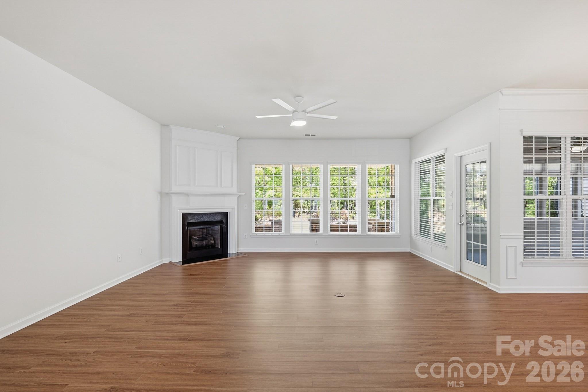 2818 Mandarin Street Fort Mill, SC 29707 - Photo 8 of 48 a view of an empty room with wooden floor and a fireplace