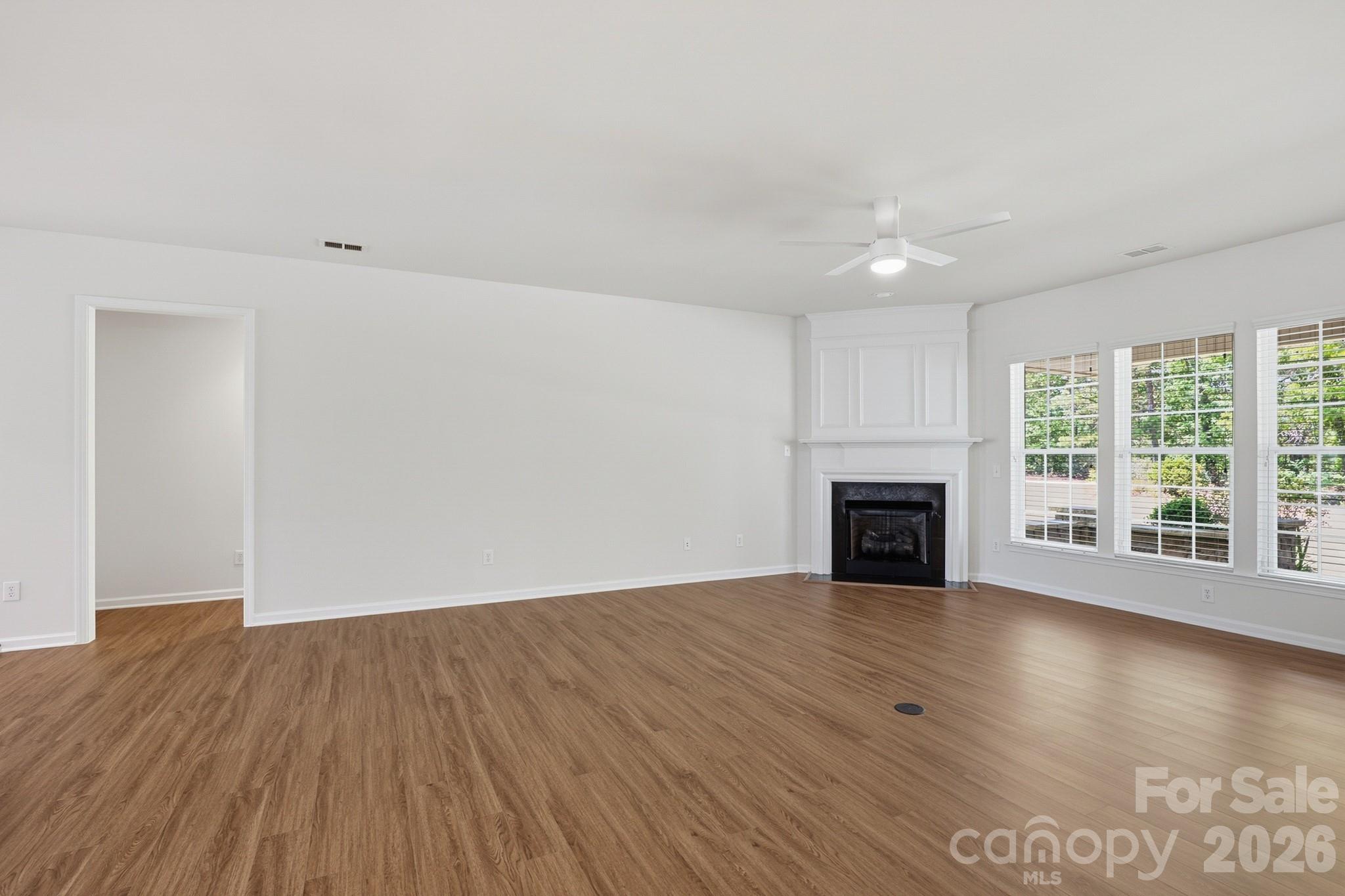2818 Mandarin Street Fort Mill, SC 29707 - Photo 9 of 48 a view of an empty room with wooden floor and a window