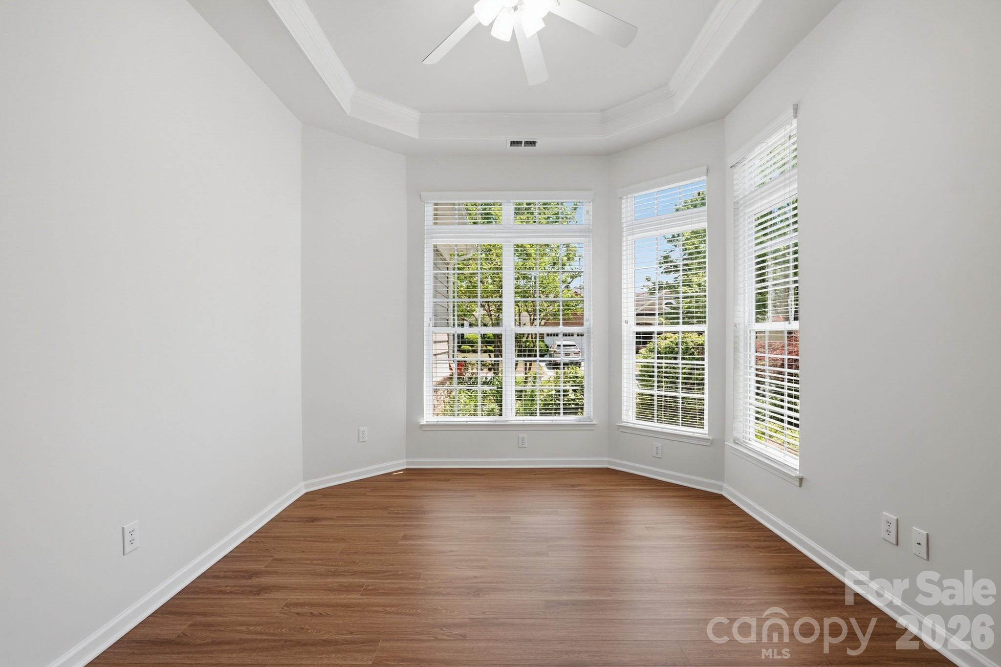 2818 Mandarin Street Fort Mill, SC 29707 - Photo 10 of 48 a view of an empty room with wooden floor and a window