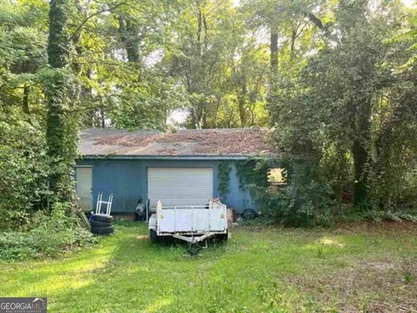 a backyard of a house with yard barbeque oven and outdoor seating