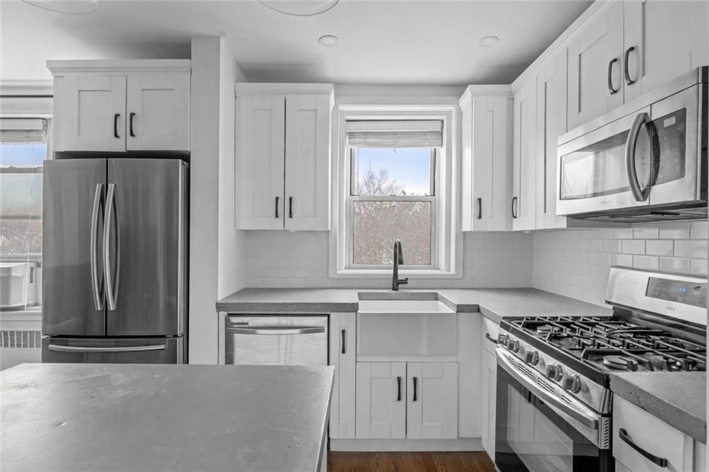 7520 Ridge Boulevard, Unit 2A Brooklyn, NY 11209 - Photo 3 of 15 a kitchen with stainless steel appliances granite countertop a stove a refrigerator and a granite counter tops