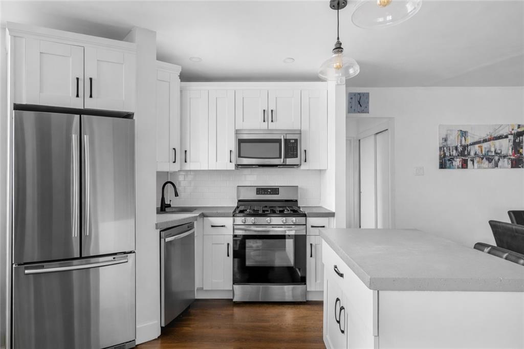 7520 Ridge Boulevard, Unit 2A Brooklyn, NY 11209 - Photo 5 of 15 a kitchen with cabinets stainless steel appliances and a counter space