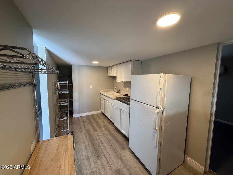 17601 North 22nd Place Phoenix, AZ 85022 - Photo 22 of 23 a view of a kitchen with refrigerator and wooden floor
