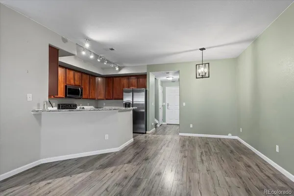 an open kitchen with kitchen island and stainless steel appliances