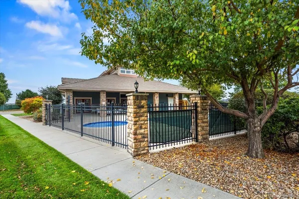 a view of a house with a swimming pool and sitting area