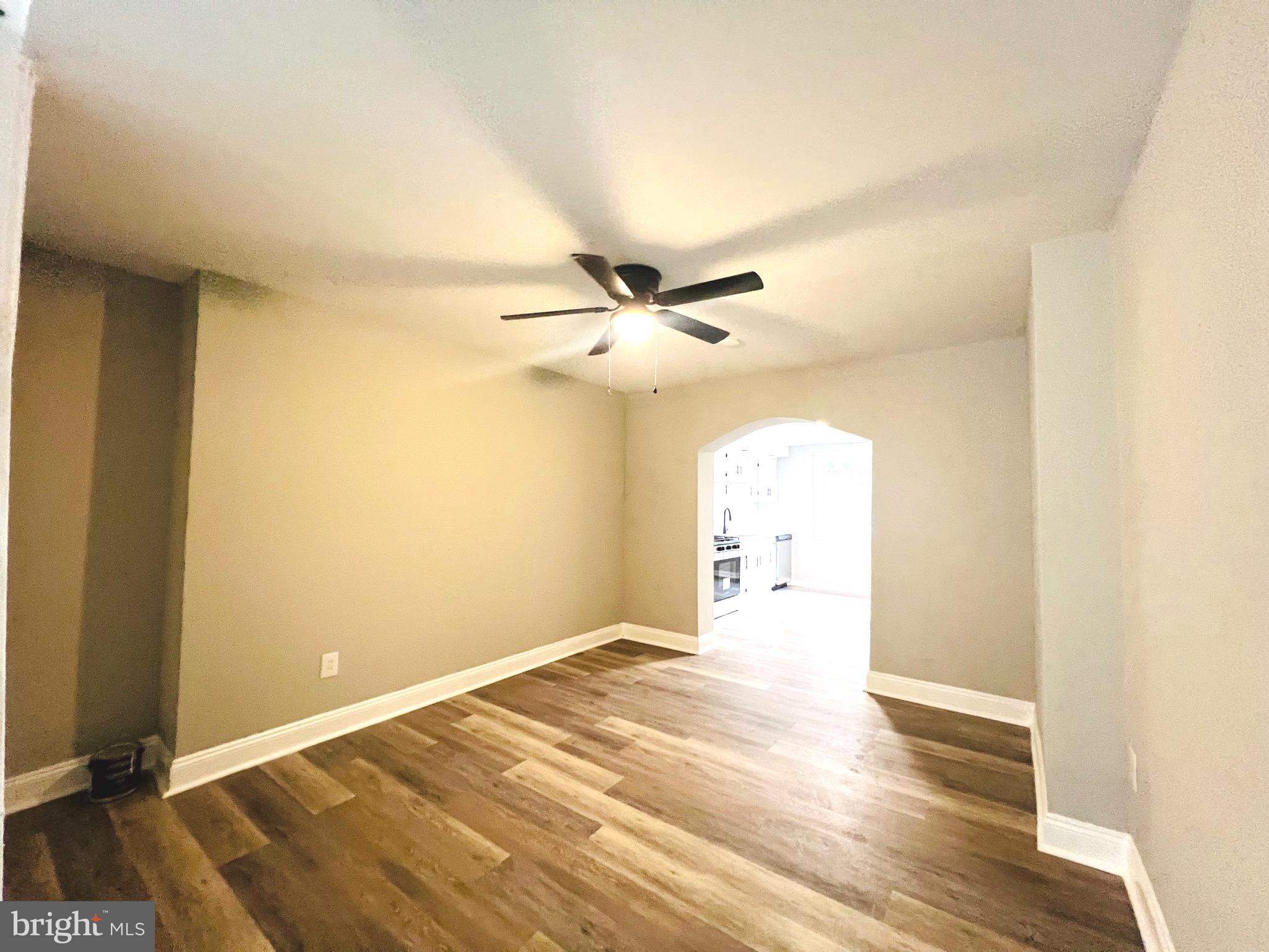 215 Middlesex Street Gloucester City, NJ 08030 - Photo 4 of 18 a view of a livingroom with a chandelier fan and wooden floor