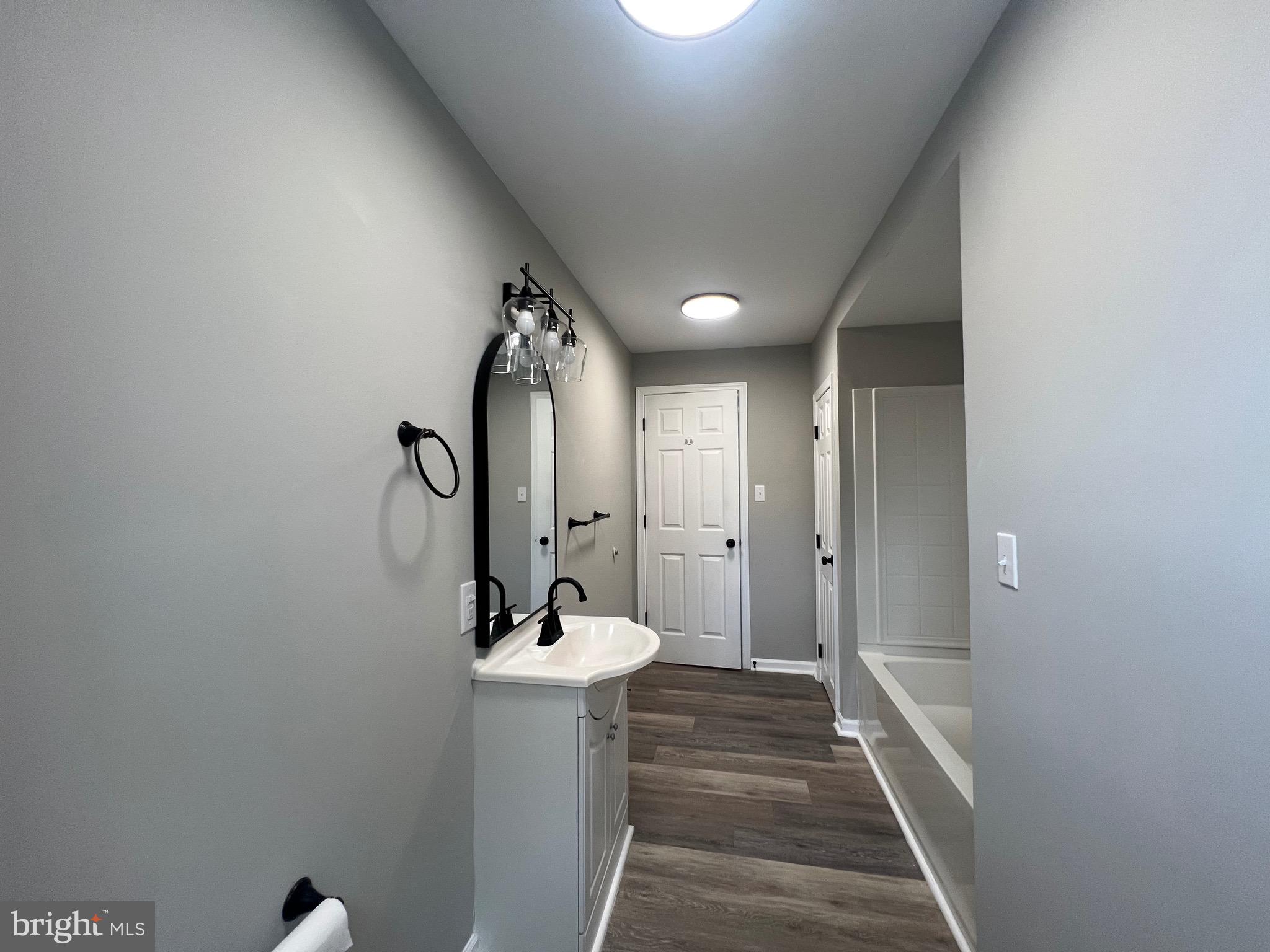 215 Middlesex Street Gloucester City, NJ 08030 - Photo 10 of 18 a bathroom with a sink and mirror