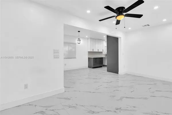 a view of a kitchen with a sink and stainless steel appliances