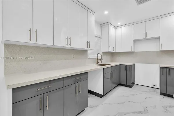 a kitchen with a refrigerator and a sink