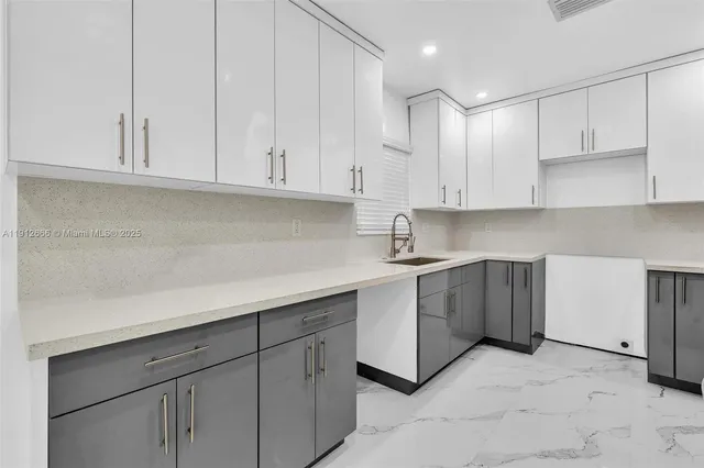 a kitchen with a refrigerator and a sink