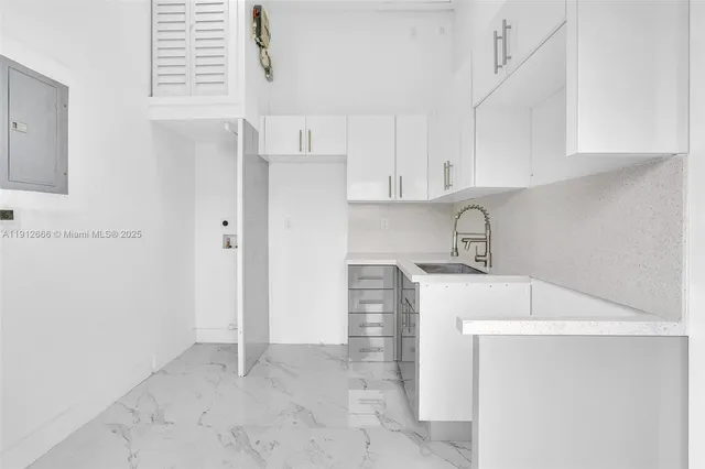a kitchen with a sink and cabinets