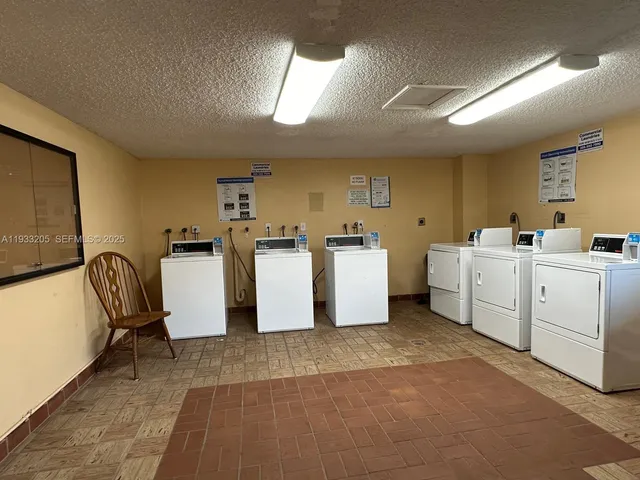 a view of a lake with a big yard and potted plants