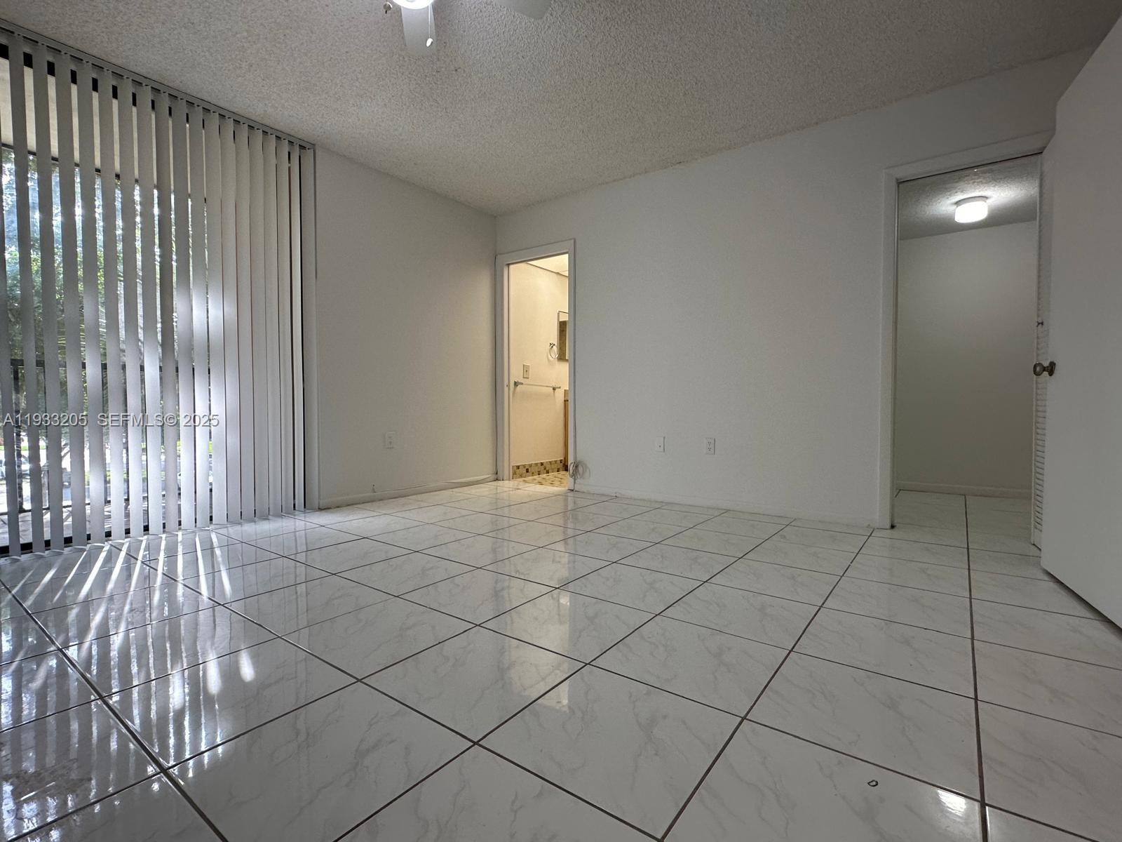 8420 Southwest 133rd Avenue Road, Unit 317 Miami, FL 33183 - Photo 2 of 22 an empty room with windows