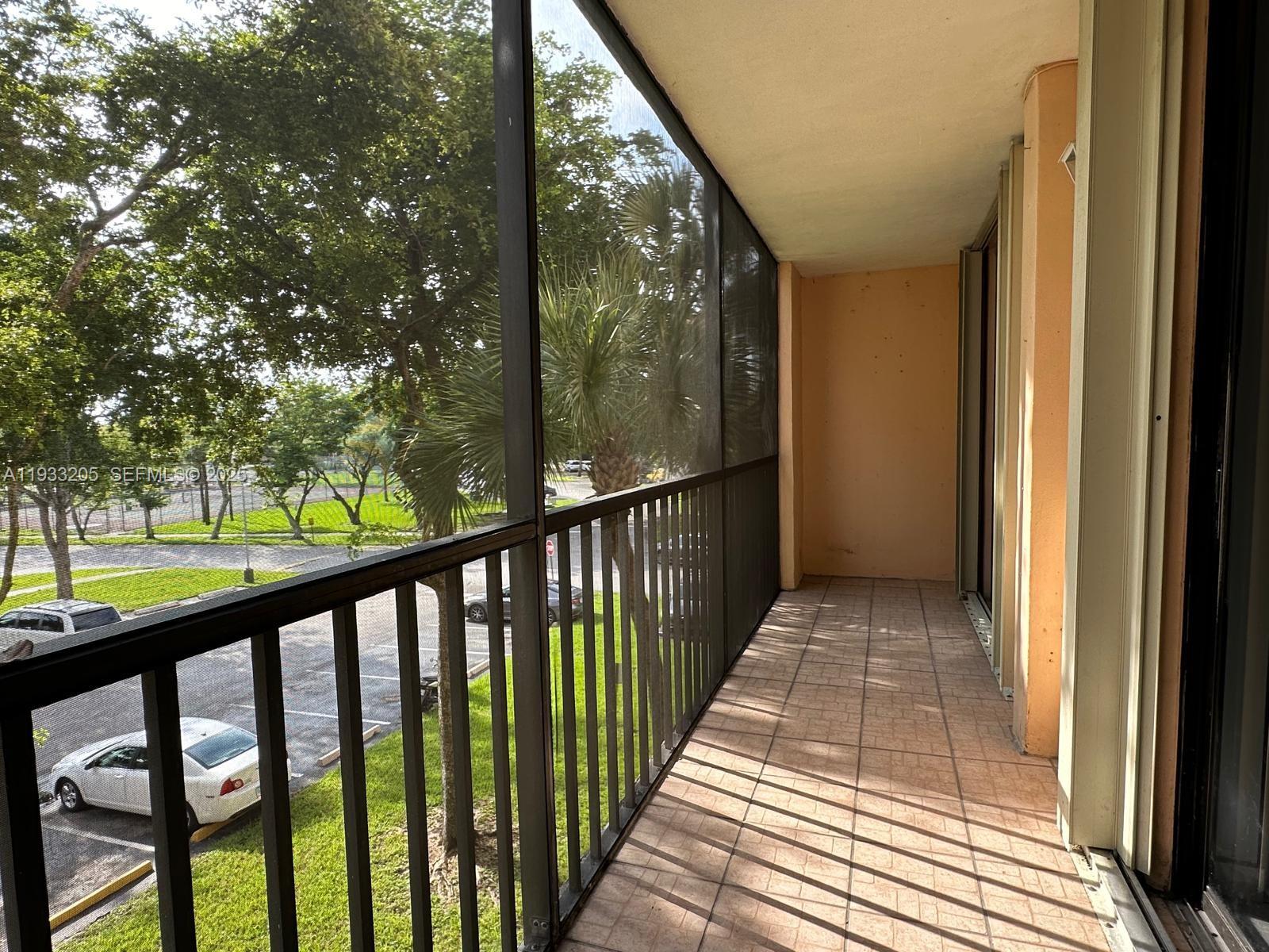 8420 Southwest 133rd Avenue Road, Unit 317 Miami, FL 33183 - Photo 4 of 22 a view of a balcony with wooden floor