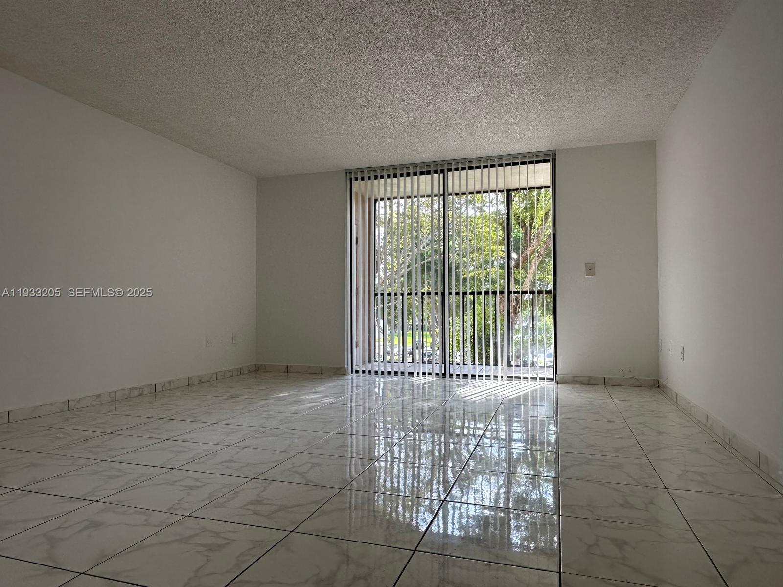 8420 Southwest 133rd Avenue Road, Unit 317 Miami, FL 33183 - Photo 8 of 22 a view of an empty room with a balcony