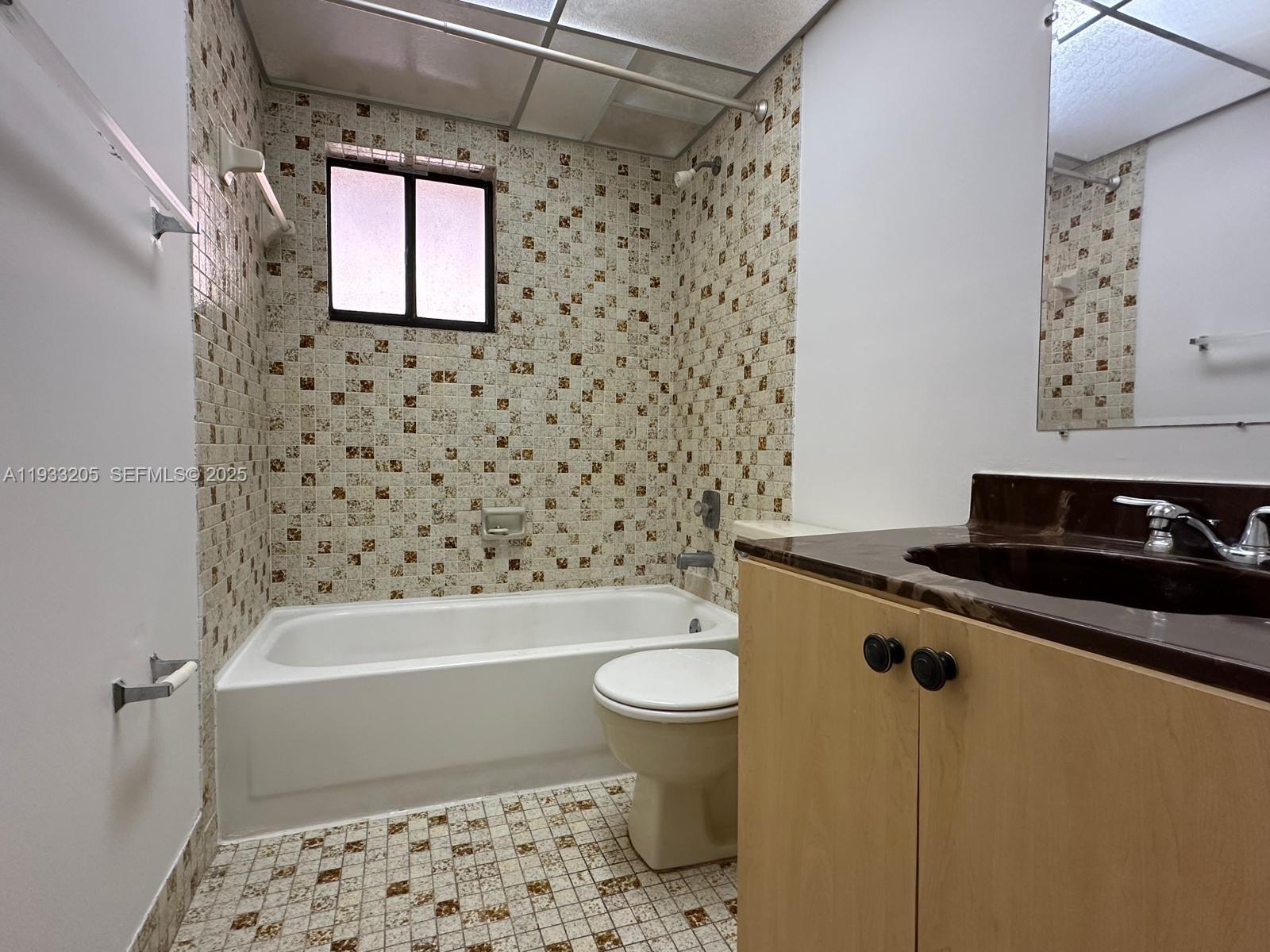 8420 Southwest 133rd Avenue Road, Unit 317 Miami, FL 33183 - Photo 10 of 22 a bathroom with a sink a toilet and shower