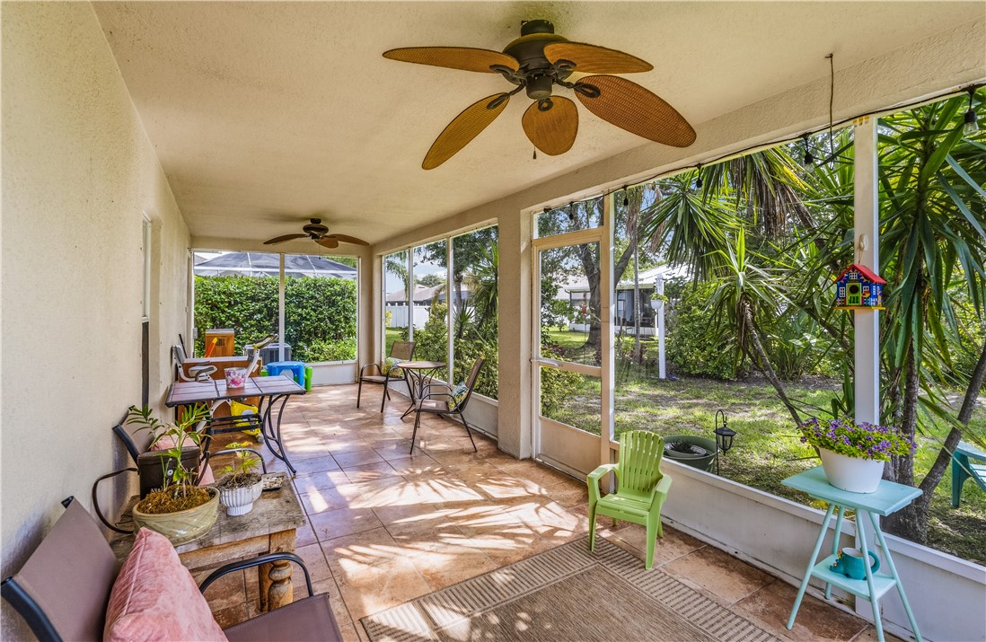 131 Bellamy Trail Sebastian, FL 32958 - Photo 4 of 32 a living room with patio furniture and a floor to ceiling window