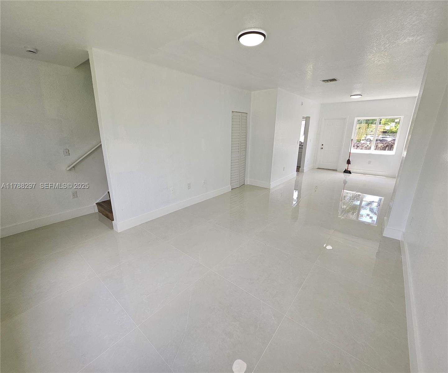 450 Northwest 84th Street, Unit 450 Miami, FL 33150 - Photo 2 of 28 wooden floor in an empty room with a window